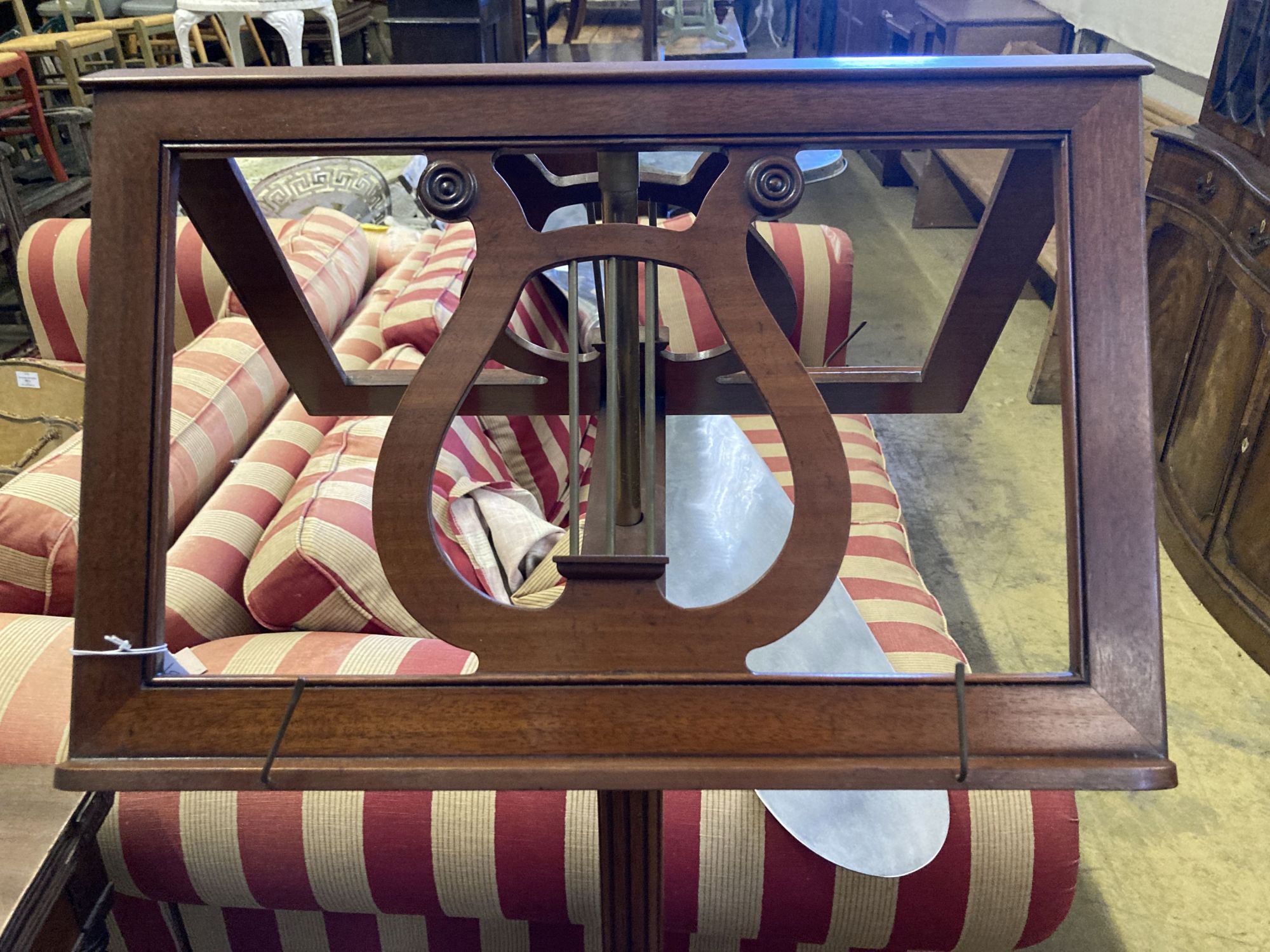 A reproduction Regency design mahogany duet music stand, width 52cm and music canterbury by Restall Brown and Clennell, Lewes